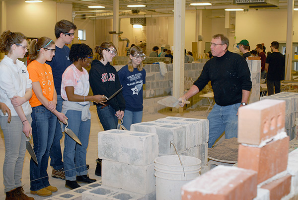 Richard R. Motter Jr., instructor of building construction masonry, puts his newest students at ease ...