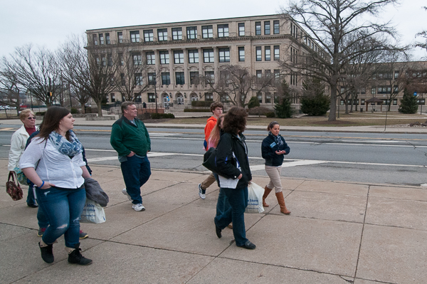 Ambassador Ashley G. Maietta, a nursing major from Hughesville, walks a tour group past the Klump Academic Center.