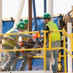 Students in a three-week roustabout training program demonstrate a drilling rig.