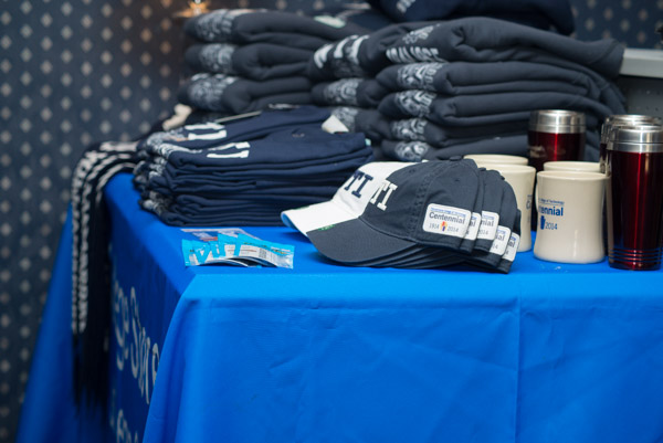 Hats, shirts, pennants and Centennial mugs adorn a table of WTI memorabilia. 