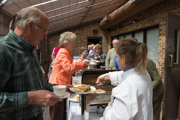 Those moving through the buffet line in the PDC atrium include 2002 faculty retiree Dale Metzker ('62, offset and letterpress printing) and wife, Sally, just behind him. 