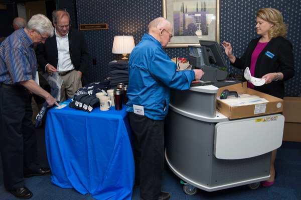 As the festivities draw to a close, Jennifer L. McCracken, general merchandise specialist, rings up purchases on The College Store traveling register.
