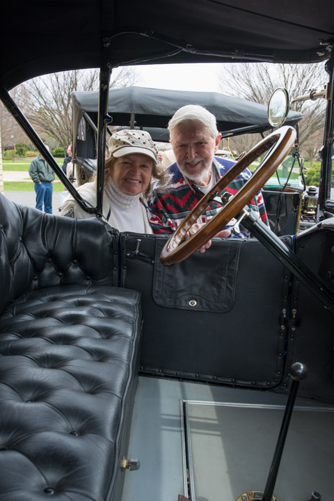 Winfield Tannehill ('57, graphic arts) and his wife, Dorothy, peek through one of the vintage cars on display in conjunction with the Automotive Centennial next-door.