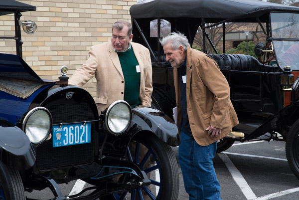 From left, Walter Doebler ('62 pattern making-wood) and Gordon Shadle ('58, machining) discuss the classic features of an antique vehicle.