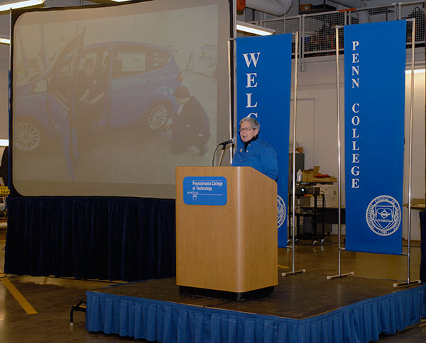 Alongside a photo of students working in an automotive lab, the president welcomes guests to a celebration of 100 years of education at one of the oldest and most-respected automotive programs in the country.