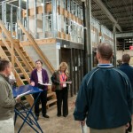 Anne K. Soucy, assistant dean of construction and design technologies, in purple, leads a group of educators through the HVAC and plumbing labs. 