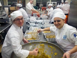 At the 2013 Kentucky Derby, Penn College students Eileen Harrington, of Springfield, Va., (left) and Laura A. Rozzi, of Reading, (a May 2013 graduate) prepare food for guests. Penn College students, including Harrington, will return for the 140th running of the Derby on May 3.