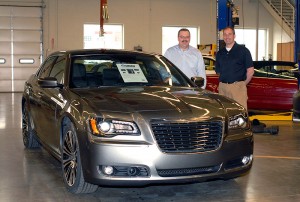 Penn College automotive instructors Chad H. Rudloff (left) and Christopher A. Trapani with a 2012 Chrysler 300, one of the first two vehicles donated by the automaker to the new Mopar CAP major.