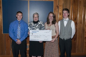 Hughesville High School’s contingent – from left, Patrick R. Hiller, Megan E. Shaner and Nesselrodt – accepts a check from college President Davie Jane Gilmour to fund its Social Change Competition proposal to build the Little Spartan Science Center in the Ashkar Elementary courtyard. 