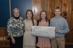 South Williamsport High School’s Sydney C. Blosser, Abby C. Nevill and Carter D. Alexander accept a check from Gilmour for the plan for an Around the World Day.