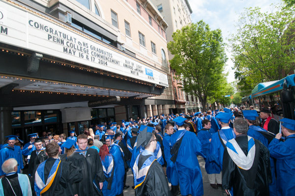 After the ceremony, graduates and their loved ones make their way to West Fourth Street. 