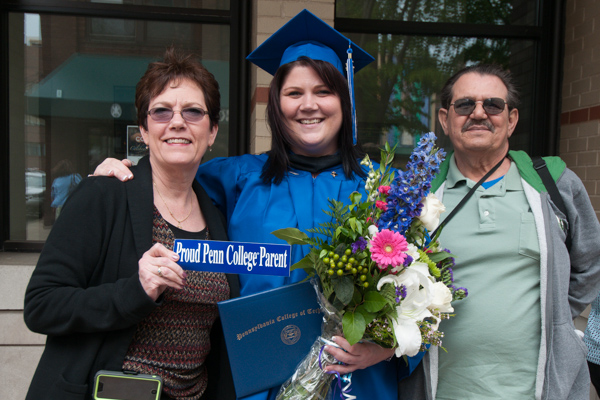 Kristi L. Papiro, a nursing graduate from Cogan Station, poses with her Penn College Proud parents. 
