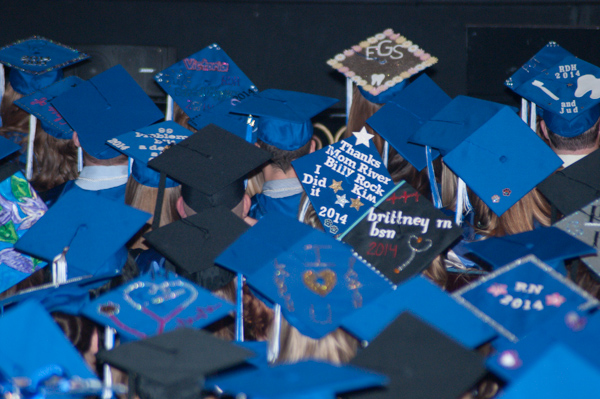 Saturday's afternoon ceremony features a dynamic and colorful array of self-decorated mortarboards. 