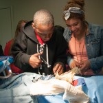 Students use operating-room tools in surgical technology.
