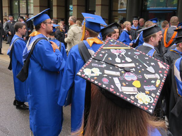 A graduate from Friday’s ceremony shows off a colorful cap.