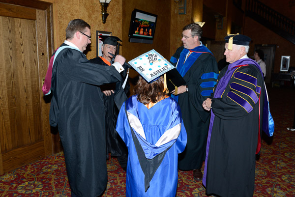 Saturday afternoon student speaker Ashley G. Maietta is greeted, from left, by Chief Student Affairs Officer Elliott Strickland, PCEA President Ken Kuhns, Provost Paul L. Starkey and Sen. Gene Yaw, chairman of the Penn College Board.