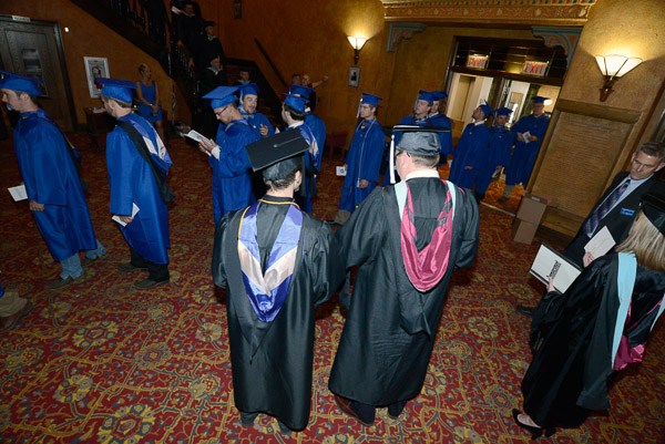 Chief Student Affairs Officer Elliott Strickland and student speaker Benjamin J. Schappell observe the processional.