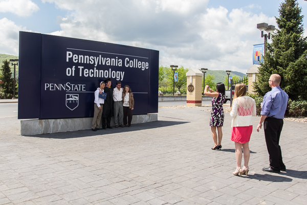 Matthew D. Shupp captures a graduation memory at the Penn College entrance. 