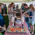 Employees enjoy picnic fare such as pulled pork, chicken, cole slaw and cupcakes.