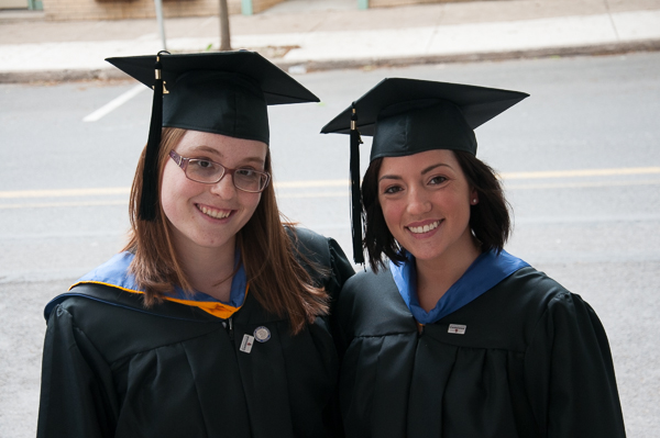 Desiree L. Buffington and Sari C. Arkin, both candidates for a bachelor’s degree in nursing, pose while waiting to walk to the Community Arts Center.