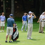 Among those gathered around the visiting pro as he scopes out the landscape are Marc E. Bridgens, the college's dean of construction and design technologies (left); Wildcat   golf coach Matt Haile (in blue shirt and sunglasses, behind Bohn); and Barry R. Stiger, vice president for institutional advancement (in yellow hat, at right).