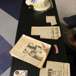 Newspaper clippings, patches and headgear are among the memorabilia displayed at the event.