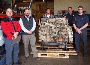 Surrounding a donated Cummins engine are, from left,  Donald Musser, service/parts manager, Cummins Power Systems; Justin Beishline and Chris Weaver, co-department heads for diesel equipment technology at Penn College; Cummins driver Brad Burkholder; and Dan Lucas, parts person, Cummins Power Systems. (Photo by Pamela A. Mix, secretary to the ESC executive director and assistant dean of transportation and natural resources technologies)
