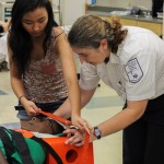 A volunteer "accident victim" is immobilized for transport in the paramedic lab.