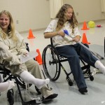 ... challenging them to put on socks with the help of adaptive equipment.