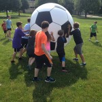 World-class-sized soccer ball wows Camp ESCAPE crowd.