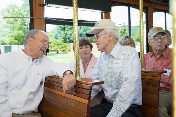 Barry R. Stiger, vice president for institutional advancement, enjoys conversation with William H. Feddersen, president of WACC from 1974-80, and wife, Roberta, as a trolley makes its way across campus. 
