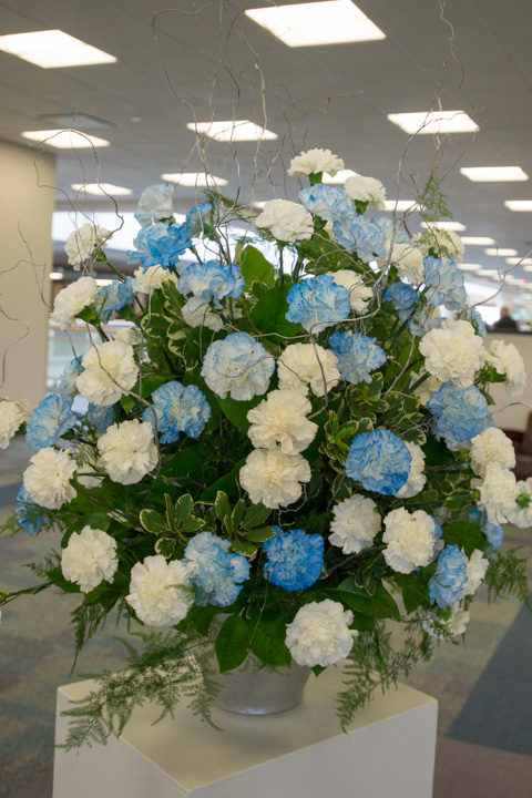 One hundred blue and white carnations comprise this fitting floral tribute from the McCormick Law Firm, among the college's scholarship benefactors.
