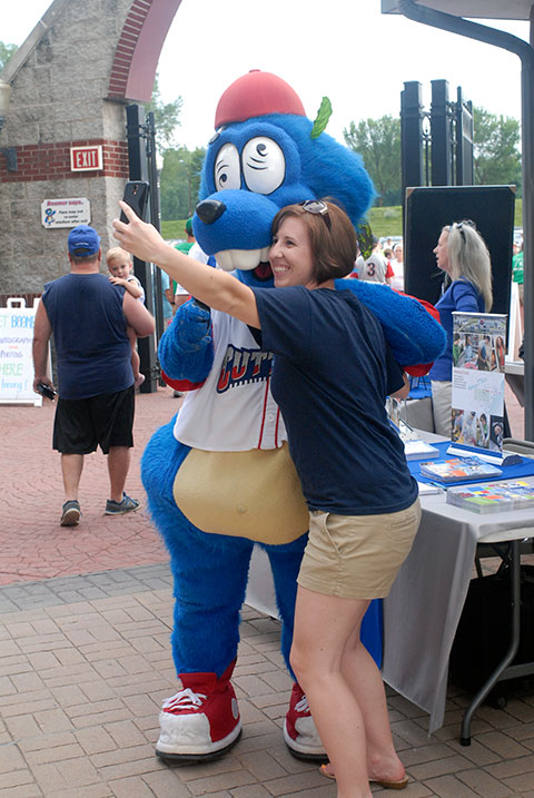 Admissions representative Sarah R. Shott (also a Penn College alumna) grabs a selfie with Boomer, the team mascot.