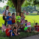 Young faces and Old Glory mingle in the shade.