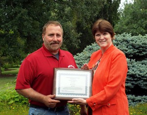 Mark E. Sones is presented with the 2014 Pathfinder to Excellence faculty award by Mary A. Sullivan, executive director of Penn College’s Schneebeli Earth Science Center and assistant dean of transportation and natural resources technologies.