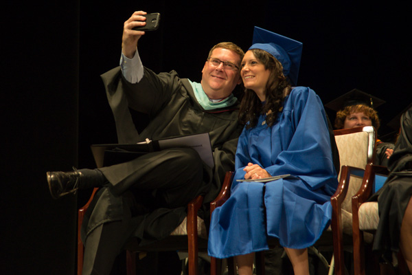 Elliott Strickland, chief student affairs officer, snags a selfie with the student speaker ... 