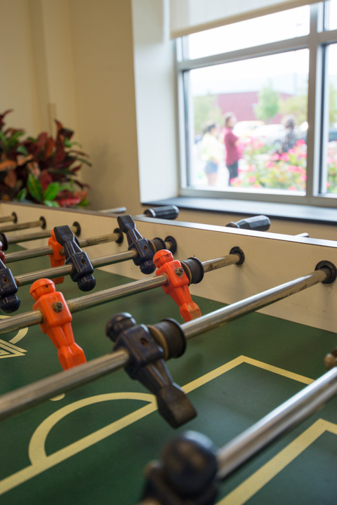 A foosball table awaits action in Dauphin while movers converse outside.