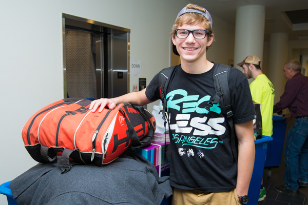 Hopeful tennis team member Joseph H. Griep, an information technology sciences: gaming and simulation freshman from Le Roy, New York, moves his gear into Dauphin Hall.