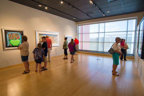 Gallery visitors enjoy discovering the intricacies of Fazzino's 