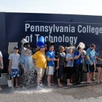 In a west-to-east wave, students dump bucket after frosty bucket over Admissions Office co-workers.