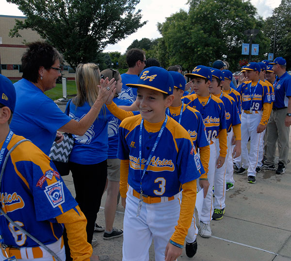 A player's smile says it all: his Europe & Africa team is playing in the Little League Baseball World Series!