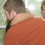 The scholarship’s first recipient, Forrest S. Martin, hugs Kanouff’s mother, Ramona.