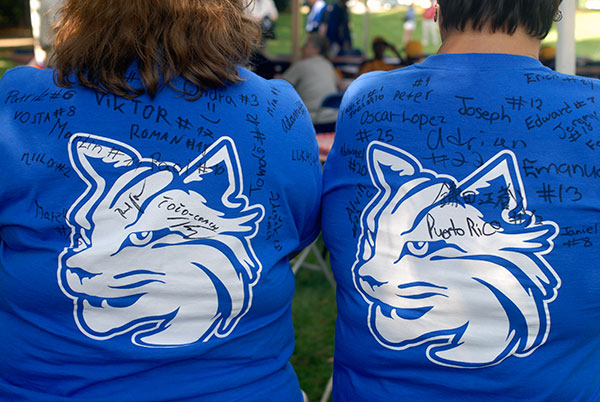 One-of-a-kind keepsakes – T-shirts autographed by the respective Europe & Africa and Caribbean teams they escorted – are proudly worn by April M. Tucker (left), an applied human services major from Muncy, and Dana R. Suter, coordinator of part-time student employment and career programs.