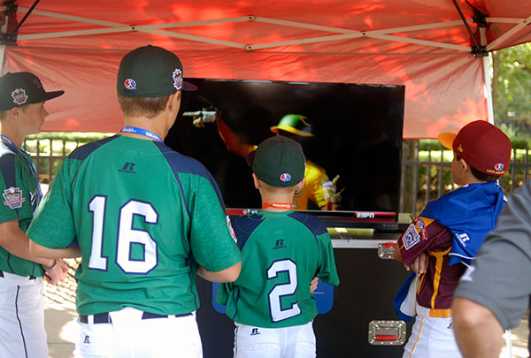 Players huddle around a TV playing highlights of the 2013 Series.