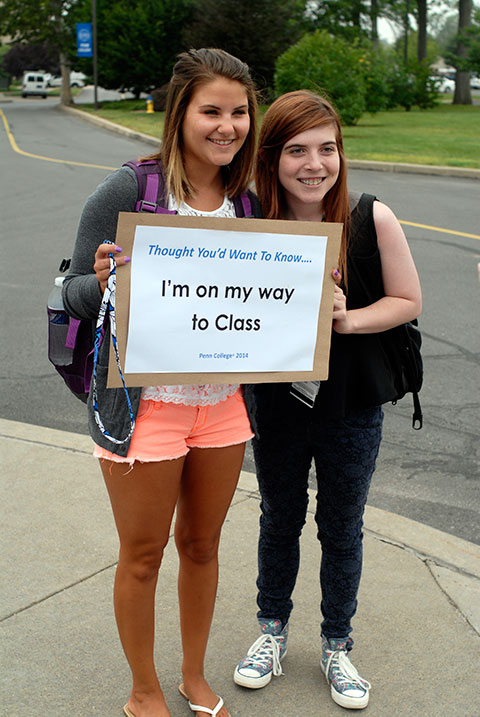 Bitting, left, with graphic design student Kelsey L.Humphrey, of Selinsgrove, let their families know that they're making it to class on time.