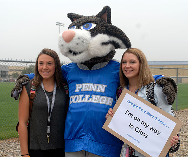 Mascot memories are made by Megan R. Fronteno,left, a pre-dental hygiene student from Cyclone, and Cheyenne M. Lutz, a pre-nursing major from Snow Shoe.