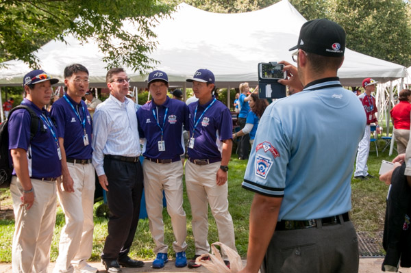 Little League International’s President and CEO Stephen D. Keener (center), obliges a photo request from the Asia-Pacific team from Seoul, South Korea, then requests one of his own to send to a good friend in Korea.