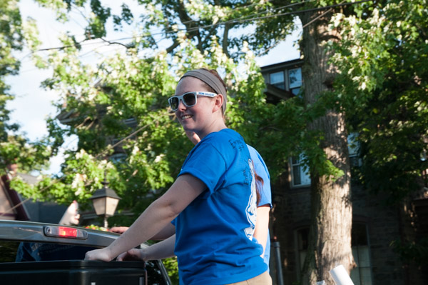 Student Activities Assistant Julie H. Carr smiles offers a smile to parade-goers between helping to distribute handouts to the college’s parade walkers.