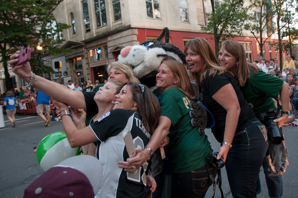 A group takes an opportunity for a selfie with the Wildcat. 