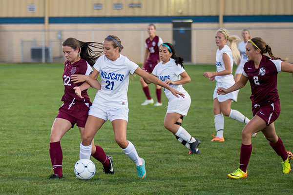 Forward Hailee L. Hartman (21), of Lampeter, goes toe-to-toe and arm-in-arm with a Rosemont defender ...